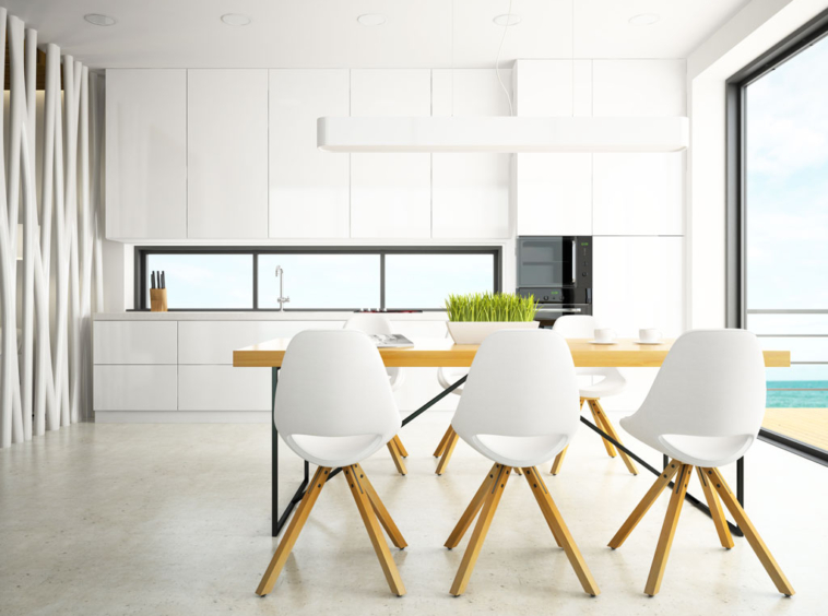 "Minimalist white kitchen with modern dining table and chairs, large windows, and natural lighting – affordable home interiors.