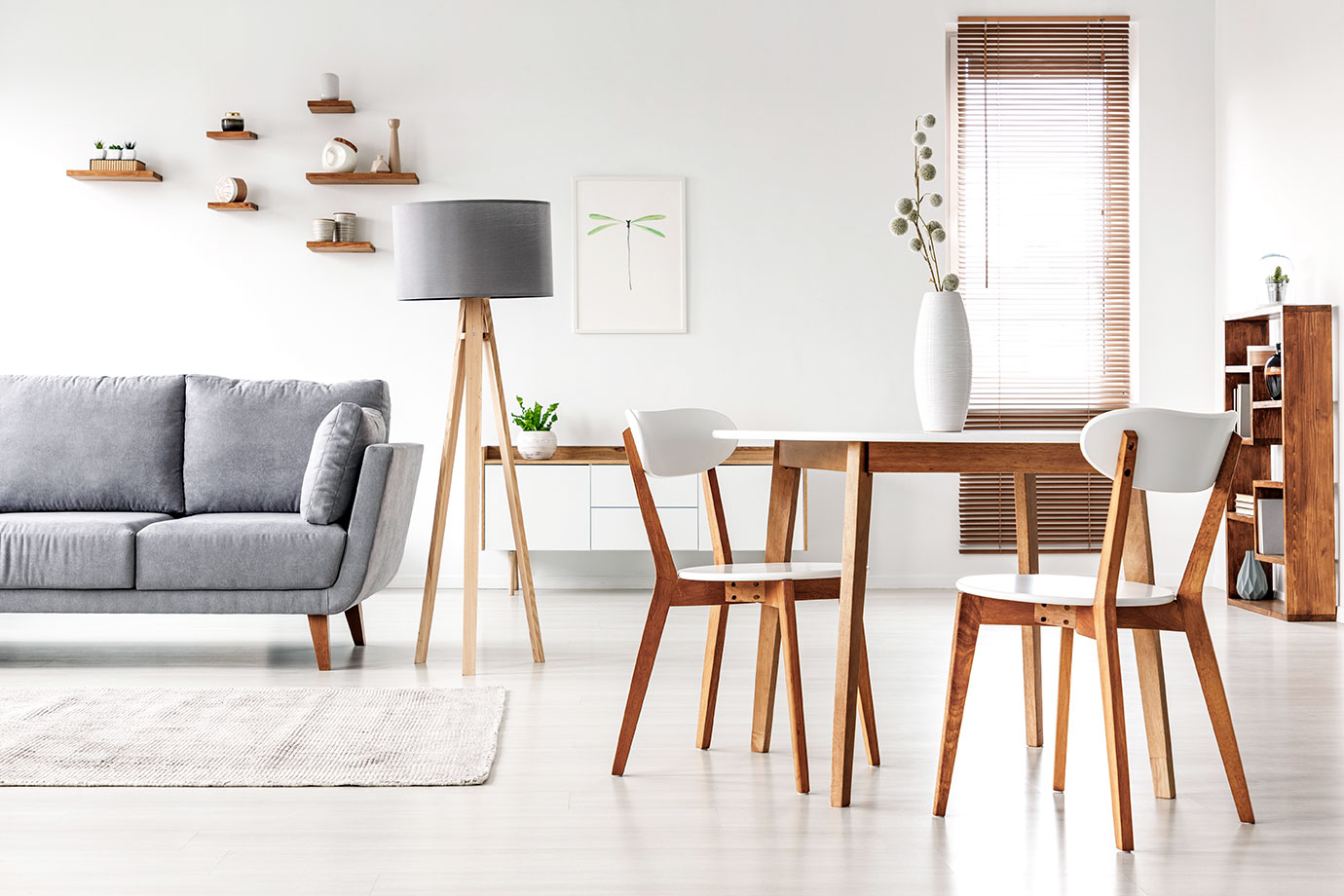 Minimalist modern living and dining room with wooden furniture and neutral decor – affordable home interiors.